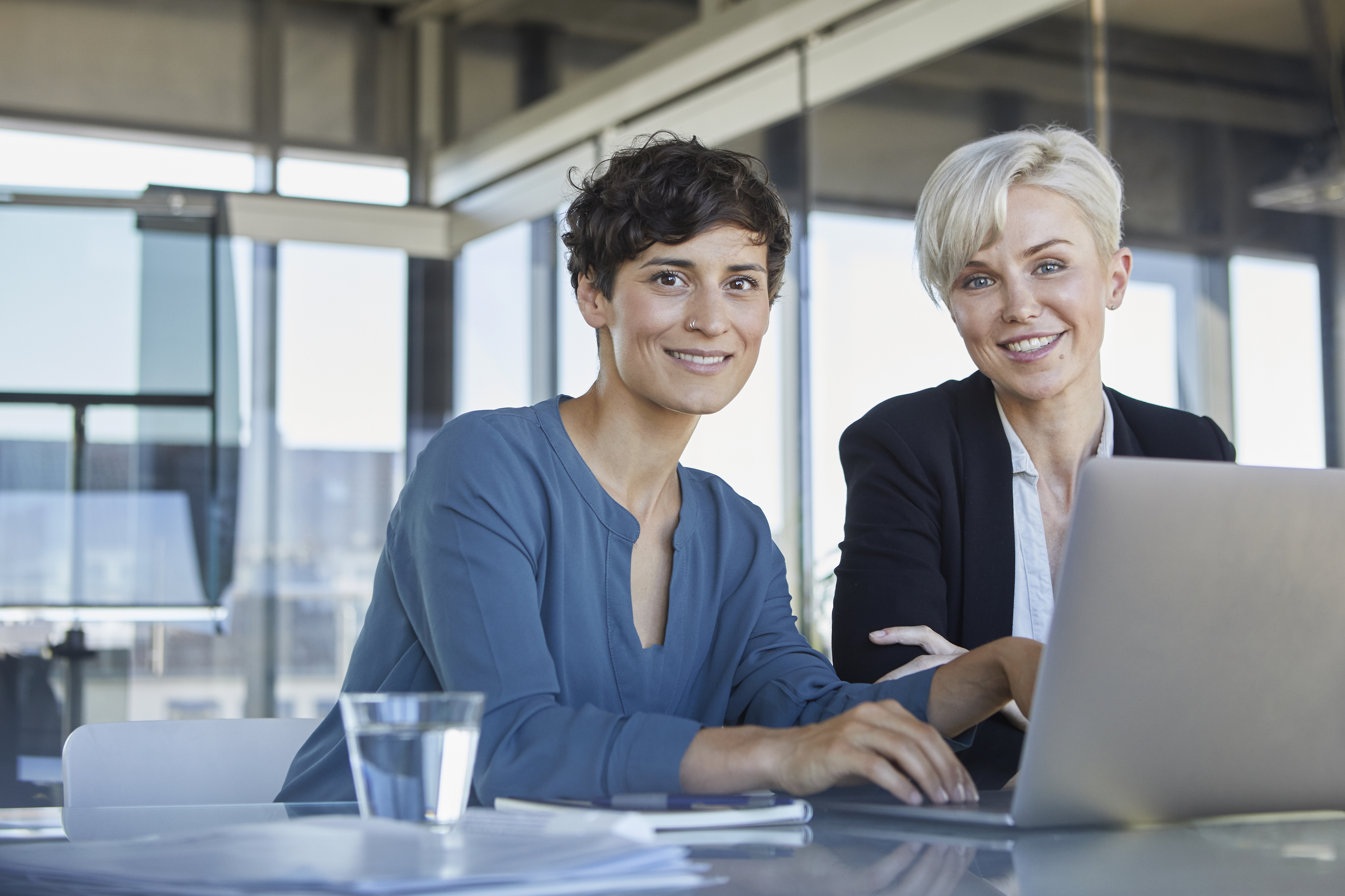 Women using laptop in business setting